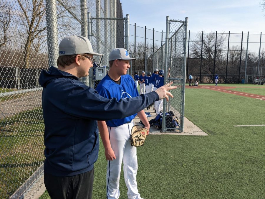 Coach Nick Gabler talks with one of his players to share some of his baseball wisdom.