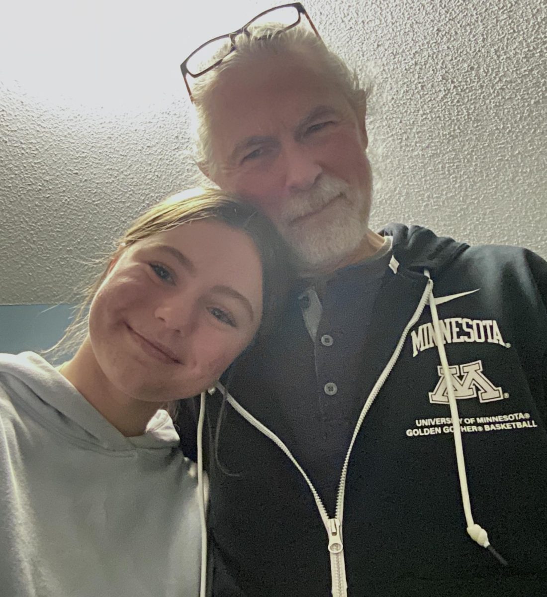My grandfather and I stifling our laughs to pose for a picture.